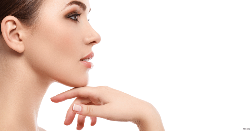 Profile of woman with sculpted jaw and cheekbone with hand touching her chin