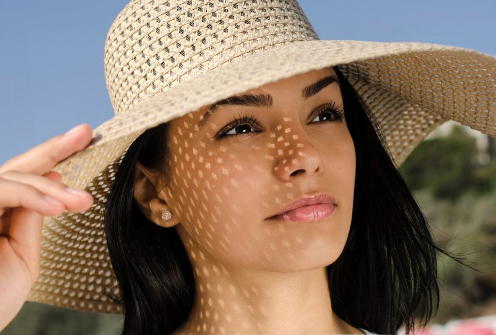 Beautiful girl with hat  looking at the sky