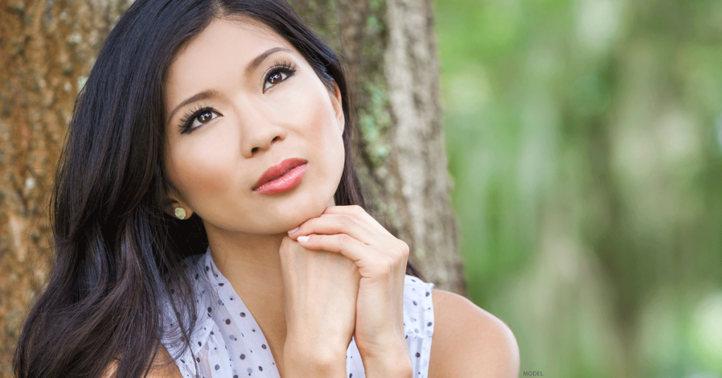 Woman with smooth facial skin looking to her left