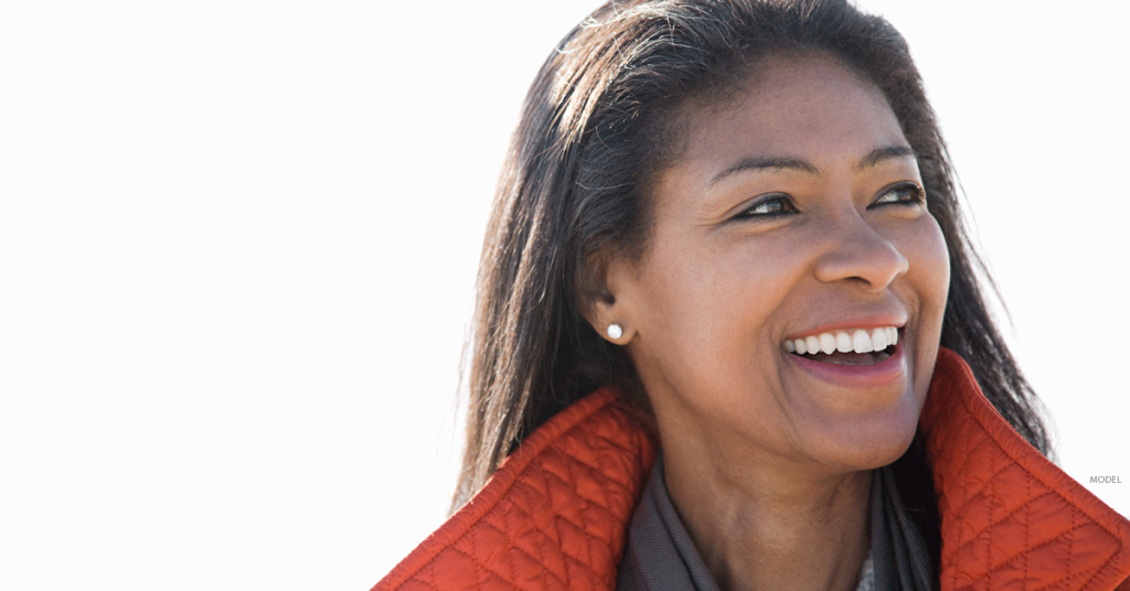 Woman with smooth skin smiling and looking to her left