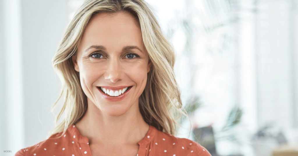 Attractive woman head shot smiling at camera